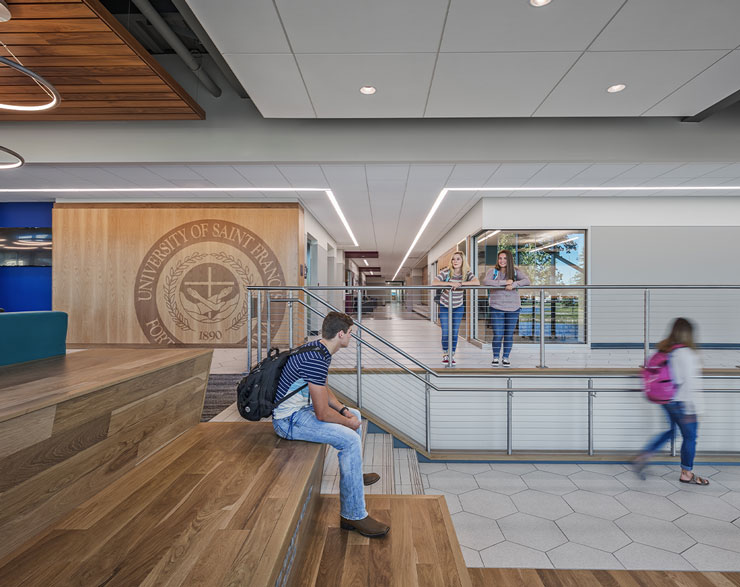 A student sits at the top of the feature stair