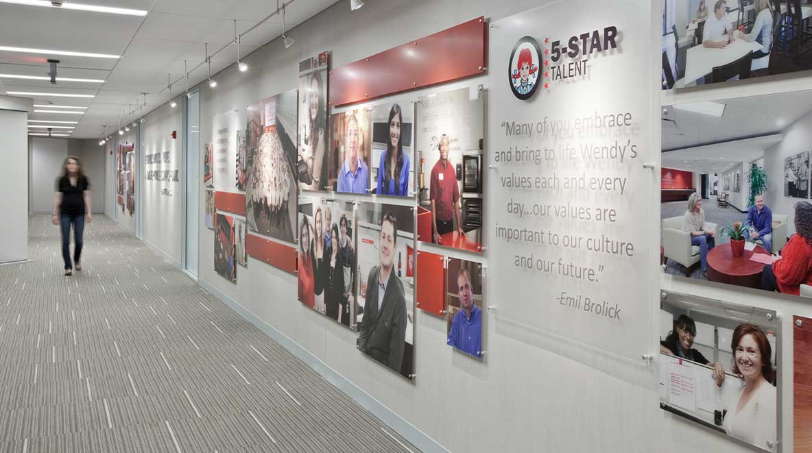 A wall filled with Wendy's photos and a statement about the company's 5-star talent