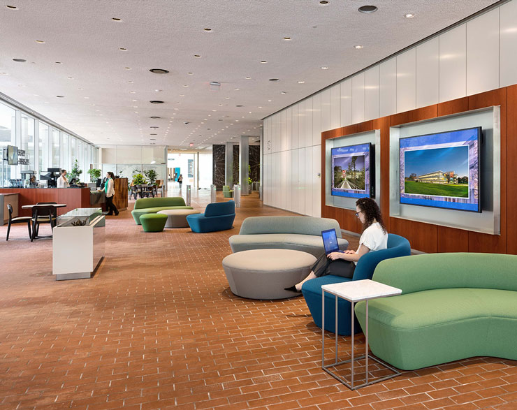 An employee works in the lobby while another grabs coffee at the new cafe