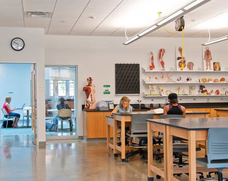 Students sit at tables inside a science classroom