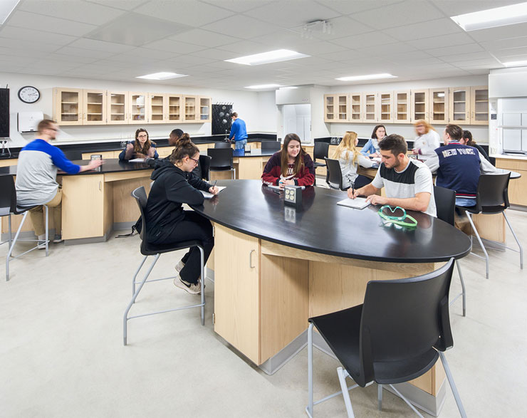 Students gather at oval-shaped lab tables
