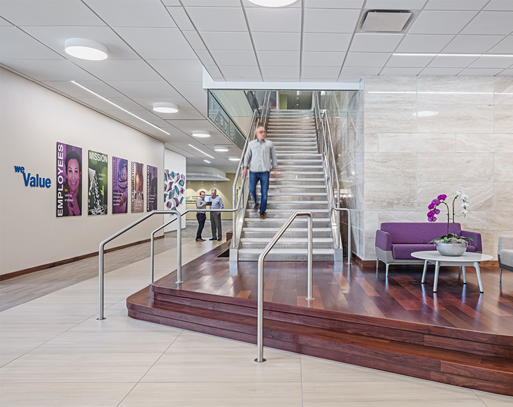 An employee comes down the grand stair