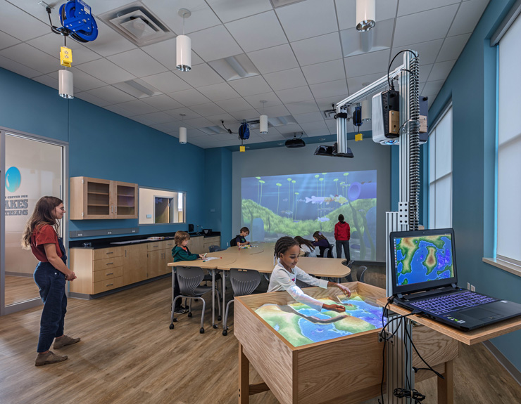 Children's gather in a room to learn more about lakes and streams