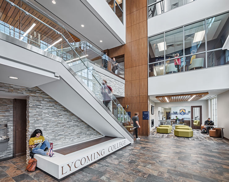 A student sits at the base of the staircase