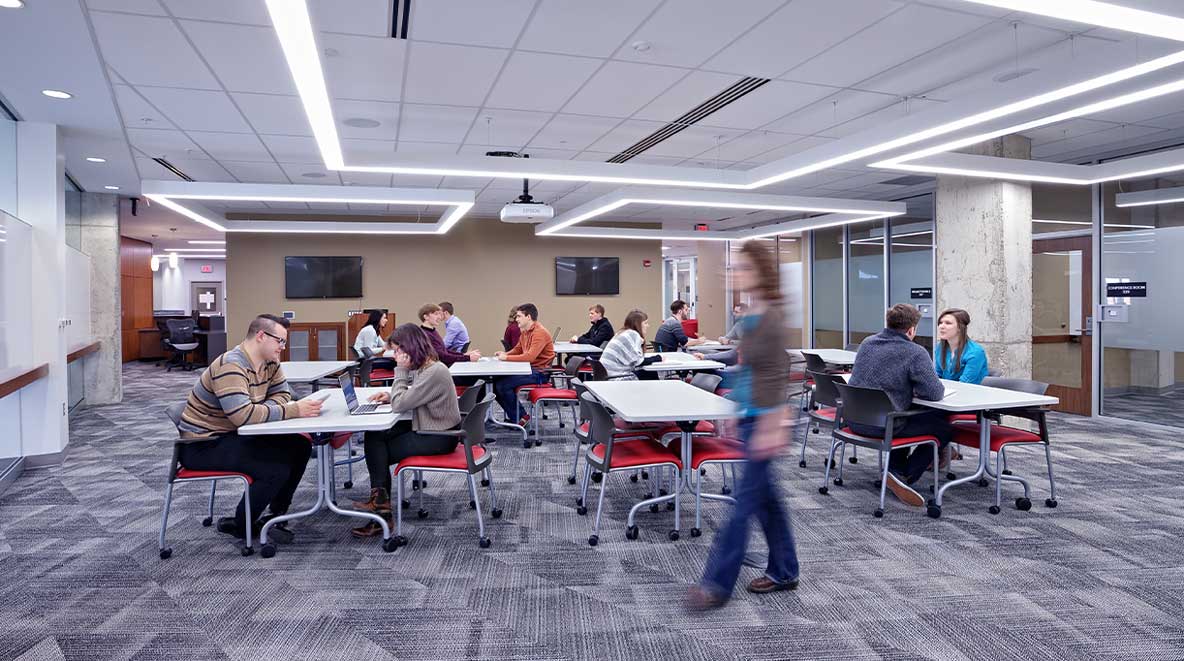 Many students are seen working in an open collaboration area