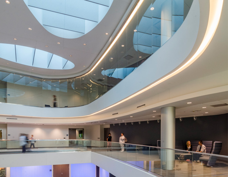 Students and faculty inside a light-filled atrium