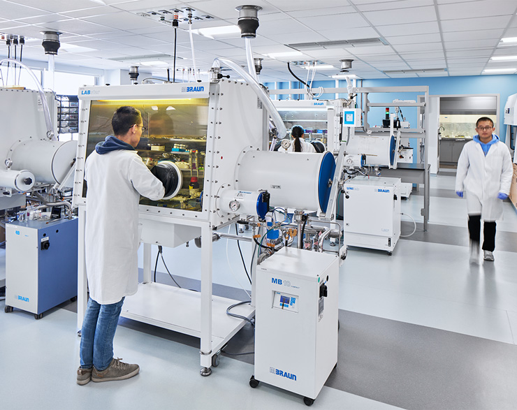 A student has their hands inside a machine 