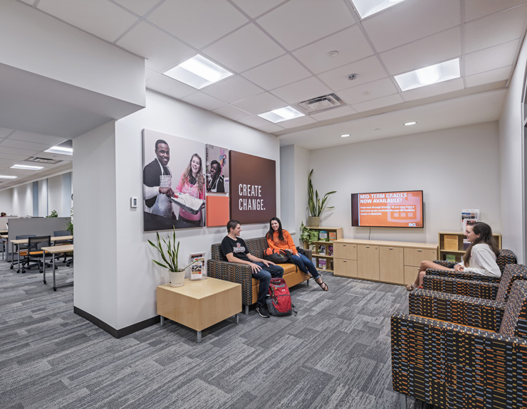 Students sit in lounge chairs across from each other