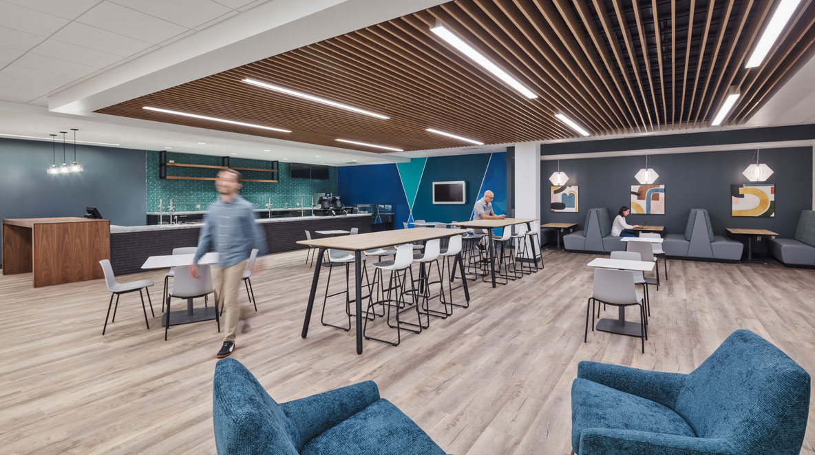 A coffee station with bar tables and booths allows employees to decompress