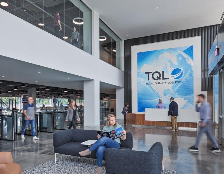 A bright and airy lobby with a large TQL sign above the receptionist desk