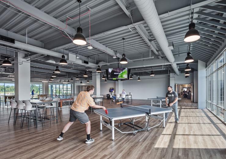 A game room where employees are playing ping pong