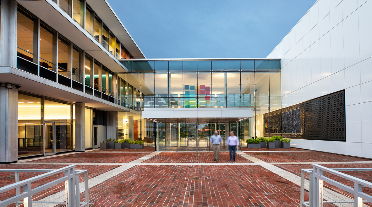 Two men are shown walking out of Altria's glass connector