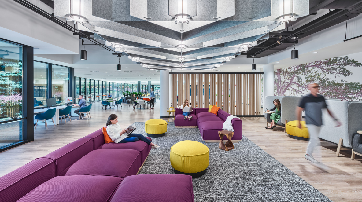 Employees hang out in the respite zone on the purple couches