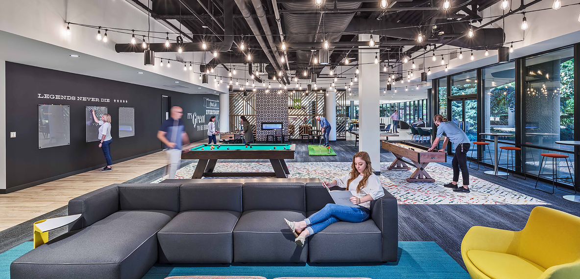 Employees hang out in an office gaming area