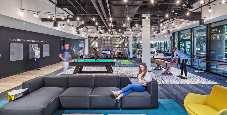 Employees hang out in an office gaming area