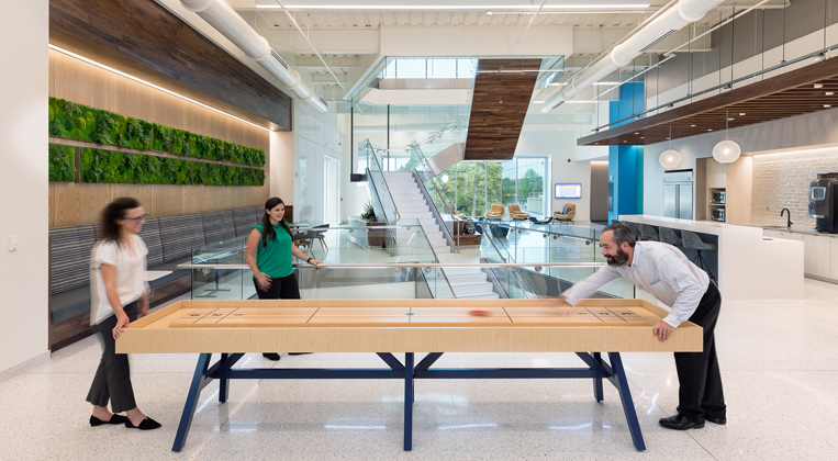 Employees playing foosball together