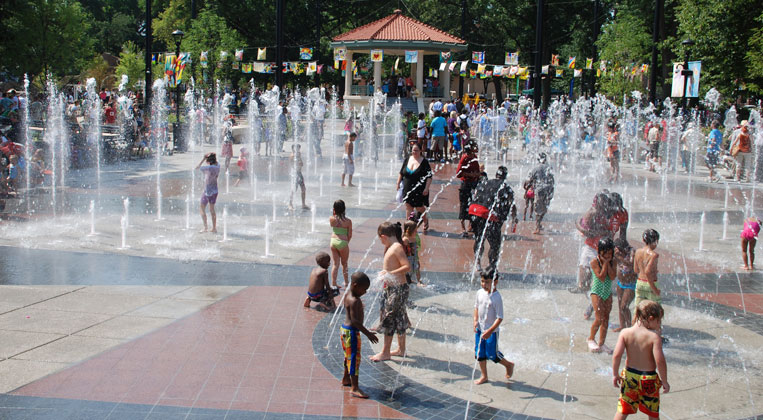 Kids playing in water fountains at Washington Park