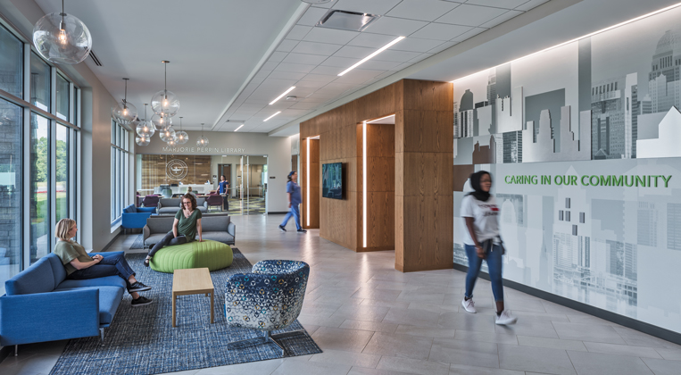 Students sit in comfortable furniture that fills a hallway at Galen