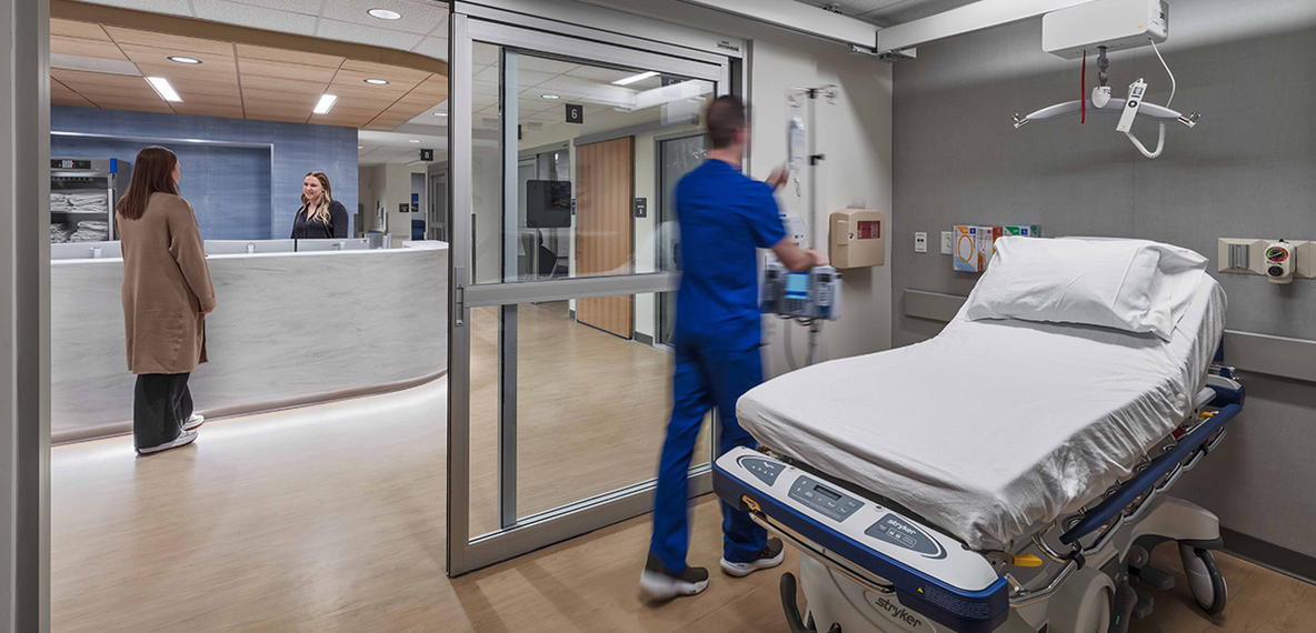 Image of a hospital room looking out at nurse's station