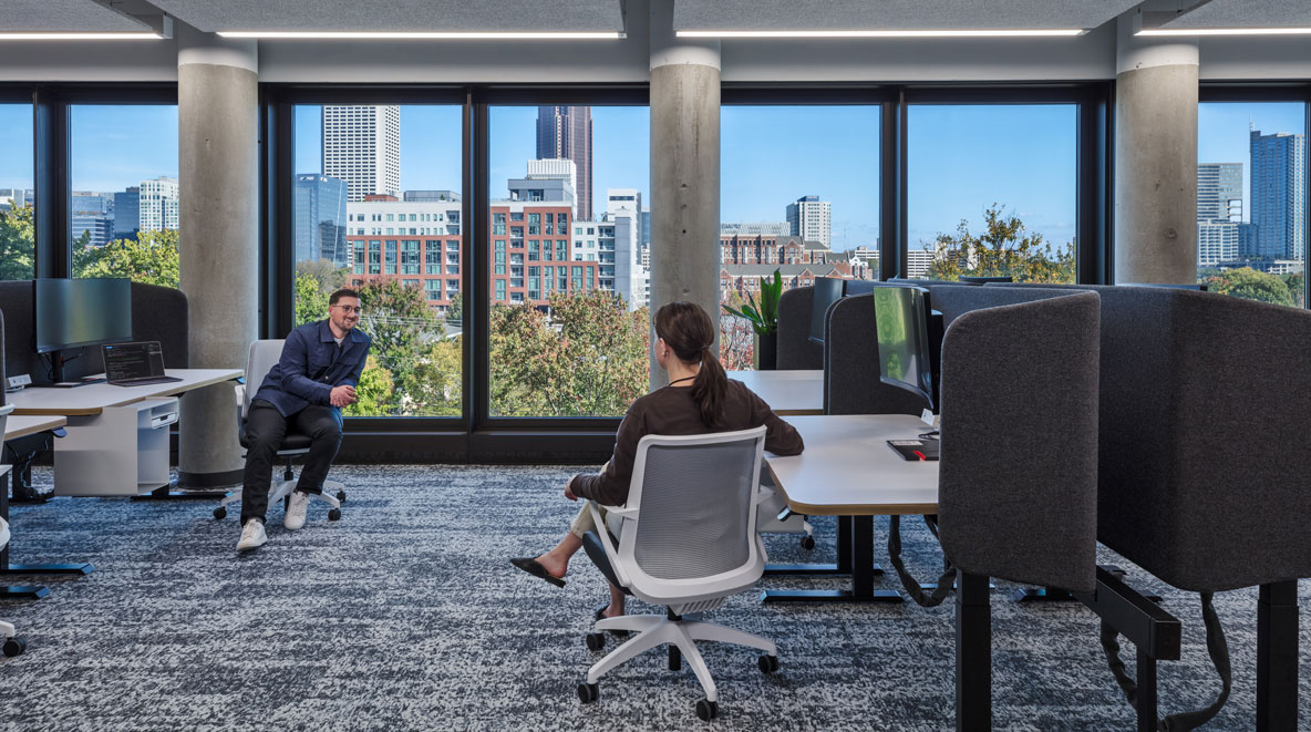 Women and man talking at desk