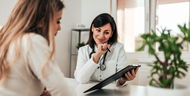 Two women, one doctor and a patient, discussing medical results 