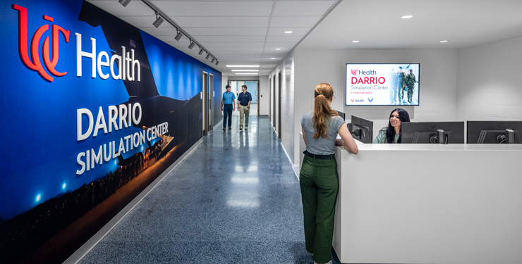 People chatting at the UC Health DARRIO Sim Center Front Desk