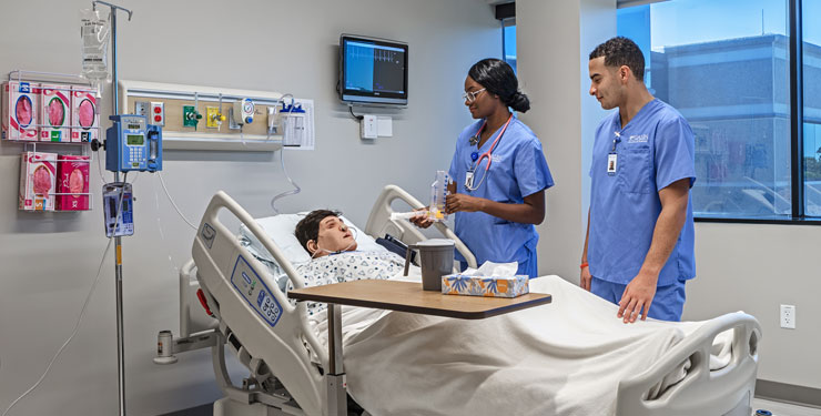 Two students in a nursing simulation lab at Galen College of Nursing Tampa campus