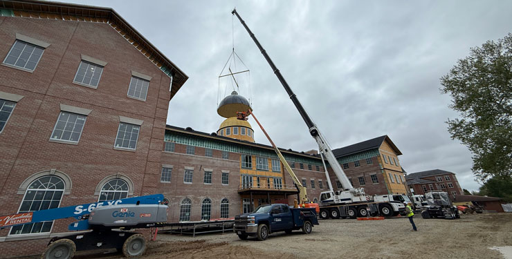 Construction crews place the 84-foot-tall dome on the Bolthouse Academic Center.