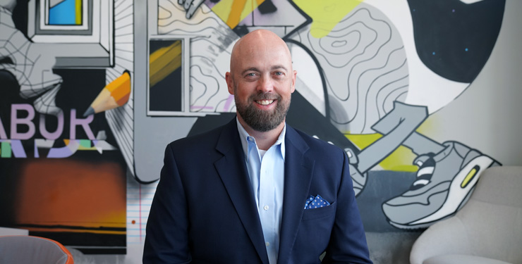 headshot of daniel lessing, new industrial market leader on BHDP mural background
