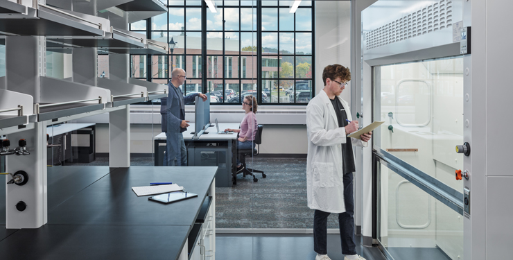 Lab bench space with adjacent glass-enclosed space for meeting.