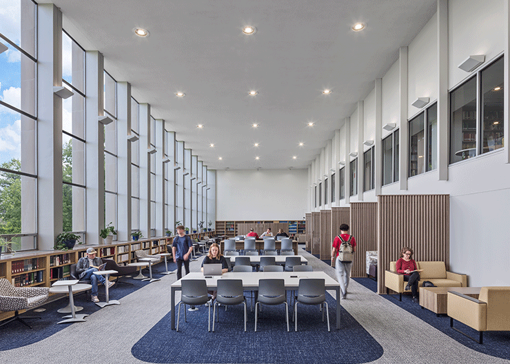 Users enjoying the Alter Library at Mount St. Joseph University, with large windows flooding the space with natural light.