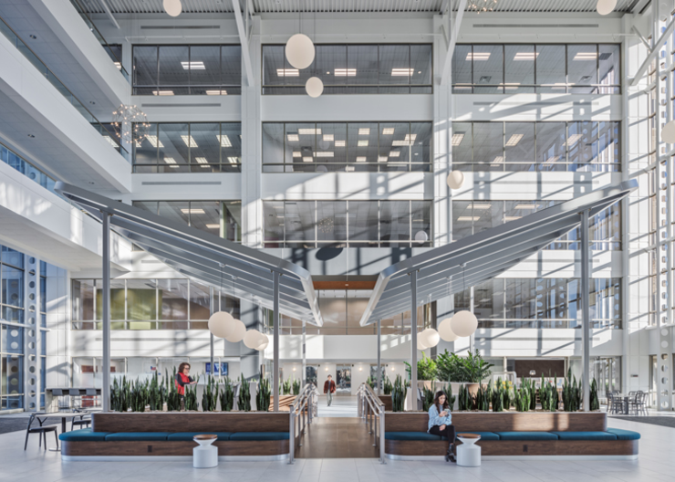 The glass atrium connects two five-story towers