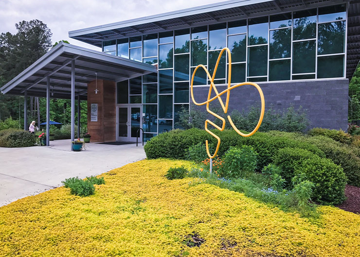 A bee-shaped piece of artwork stands at the front of the entrance