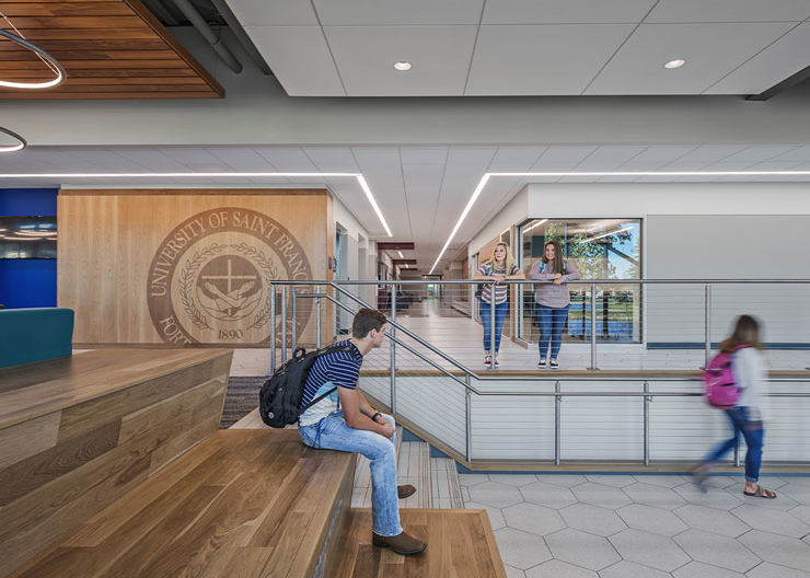 A student sits at the top of the feature stair