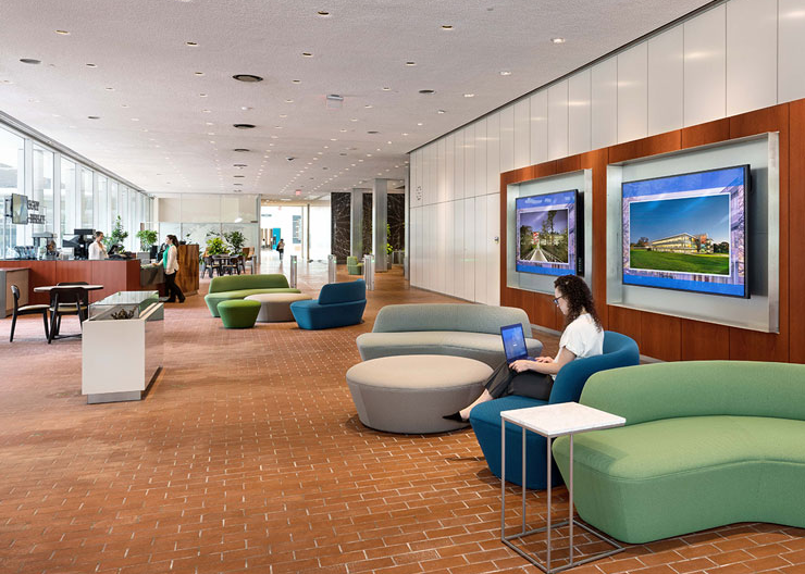 An employee works in the lobby while another grabs coffee at the new cafe