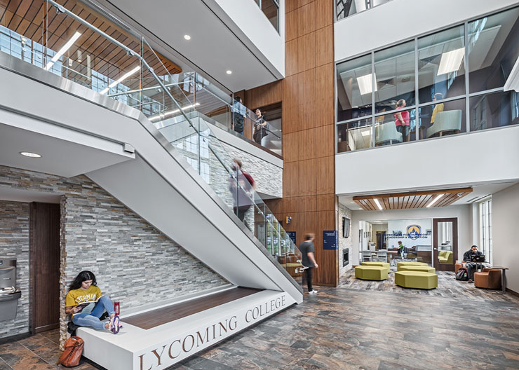 A student sits at the base of the staircase