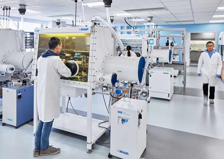 A student has their hands inside a machine 