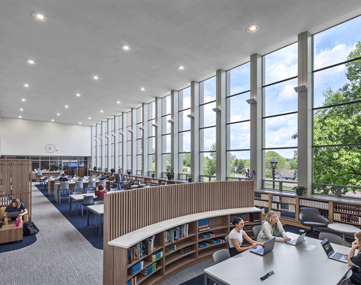 Users enjoying the Alter Library at Mount St. Joseph University, with large windows flooding the space with natural light.