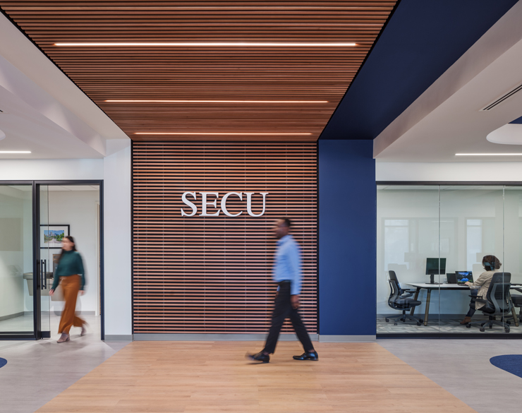 SECU's logo stands prominent against a wood slat wall