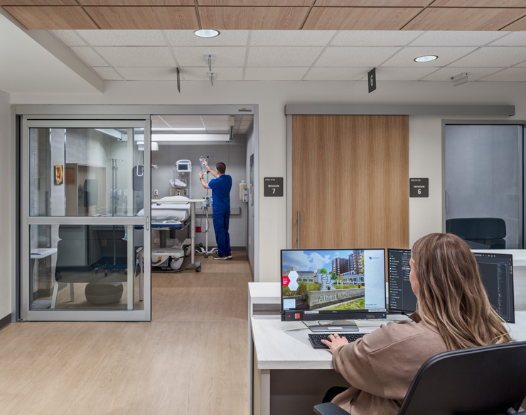 Nurse in infusion center and worker on desktop