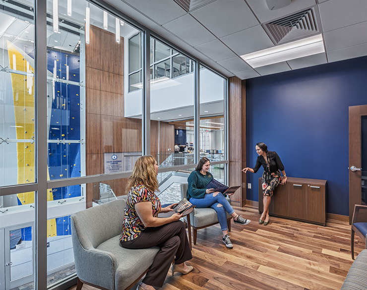A student and her mom talk with an advisor in a private meeting room