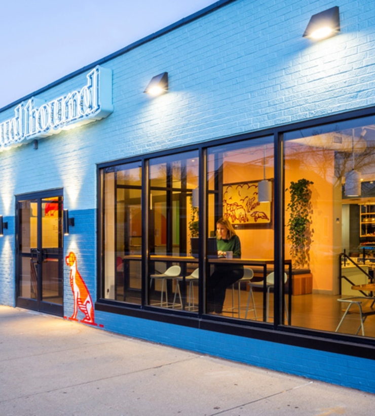Image of windows on Proud Hound exterior with view of the coffee shop interior