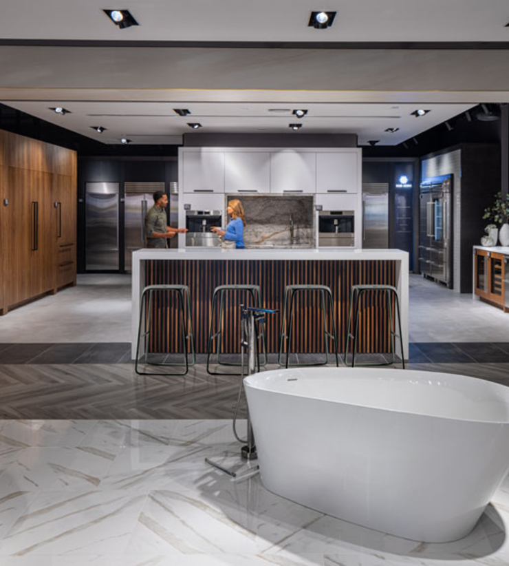Customer and architect conversing in a kitchen display at Ferguson Studio Showroom