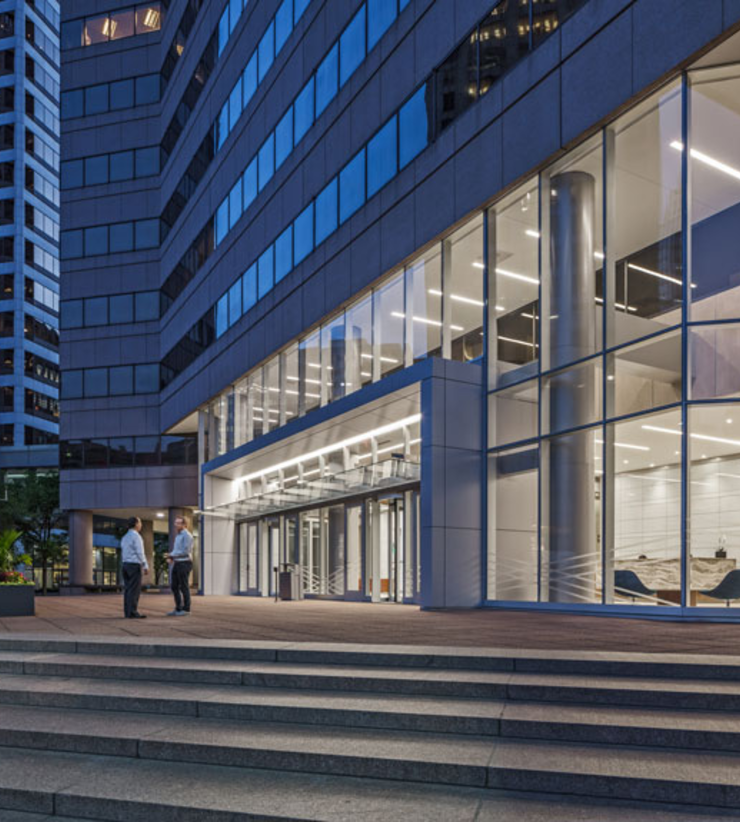 Two people talking outside of the Columbia Plaza Lobby