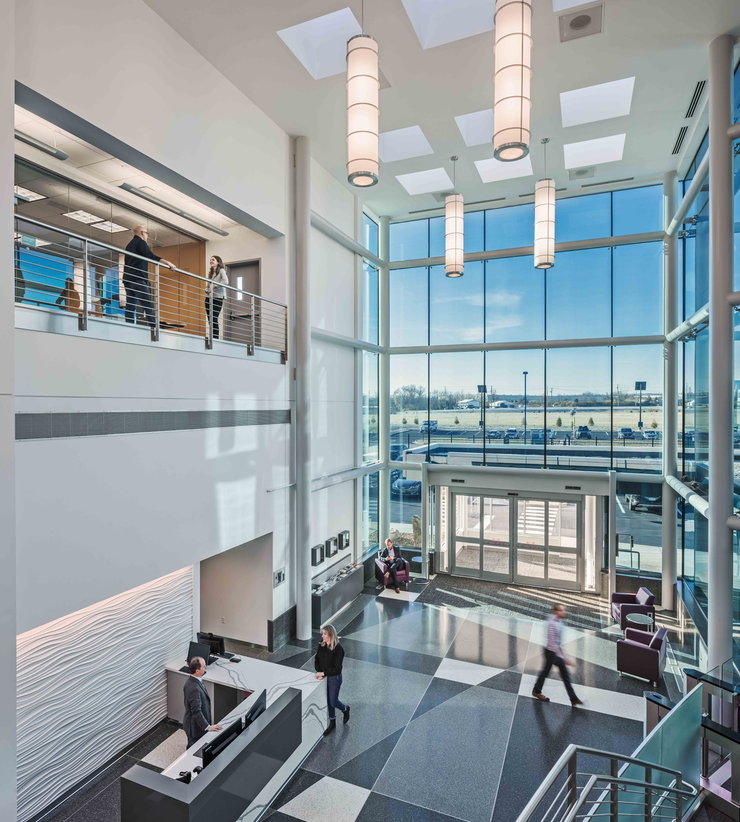 Downward view of the interior of Astrazeneca's new lobby with large, glass, entry wall