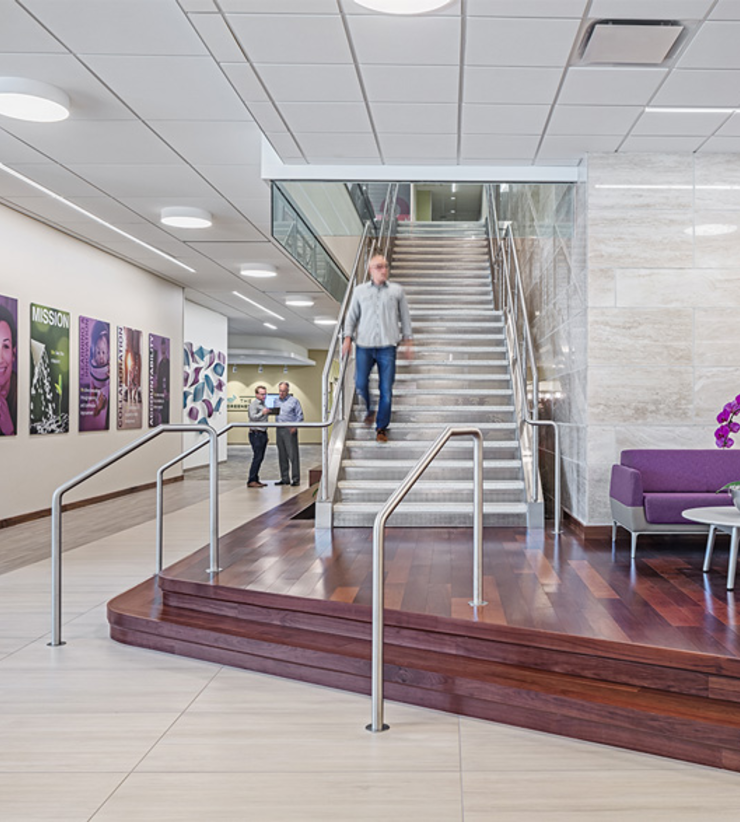 An employee comes down the grand stair