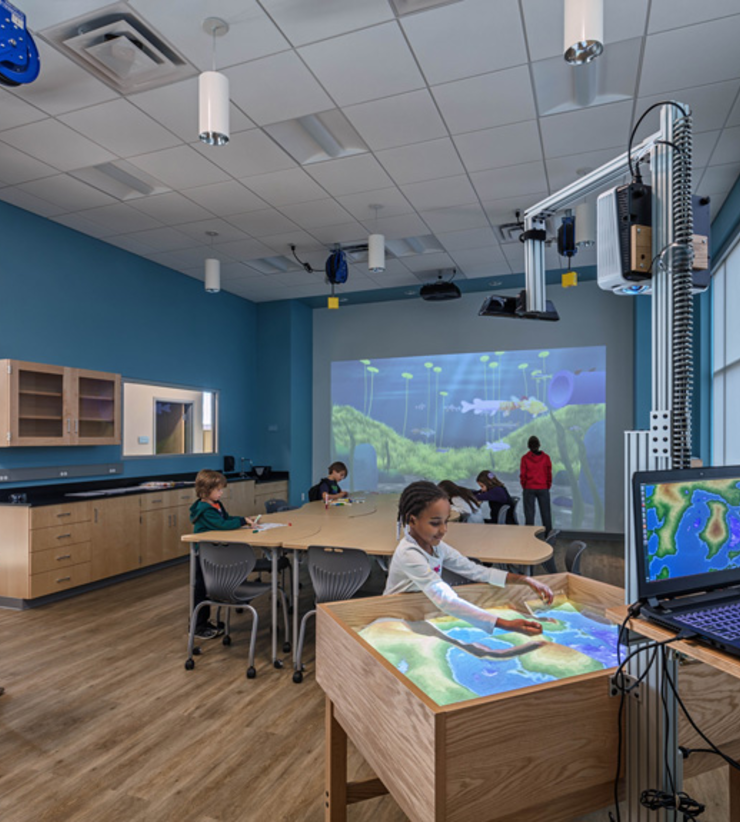 Children's gather in a room to learn more about lakes and streams