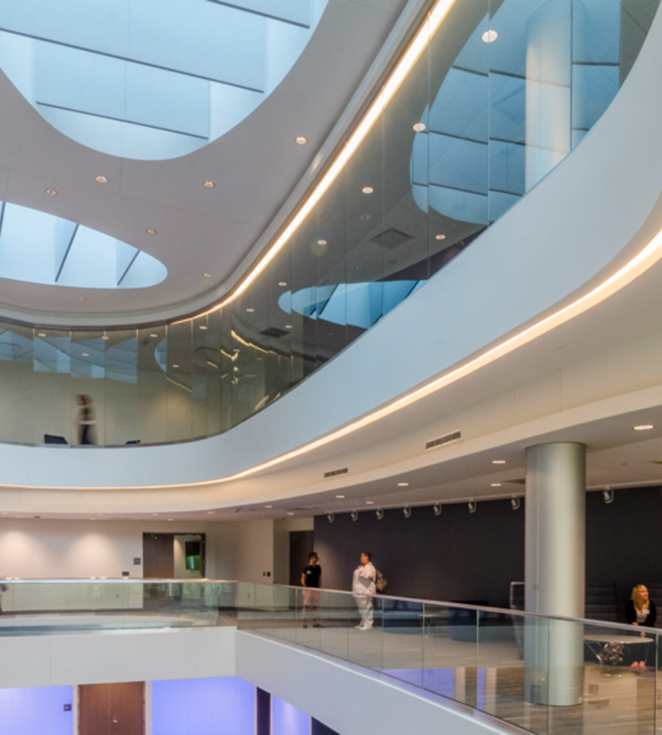 Students and faculty inside a light-filled atrium