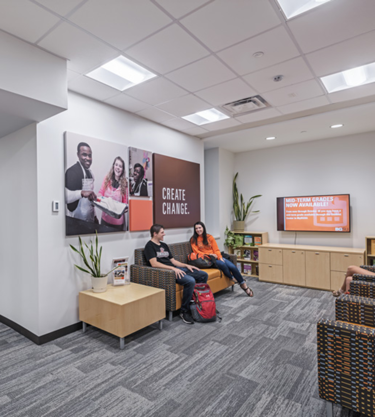 Students sit in lounge chairs across from each other