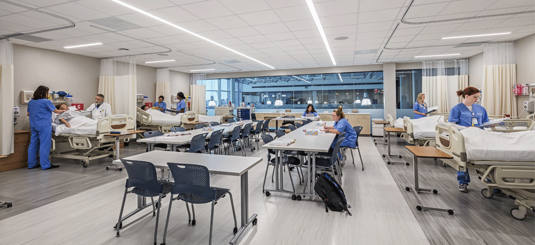 Nursing students engaged in simulation-based learning, practicing clinical skills in a controlled environment to bridge theory with real-world practice.
